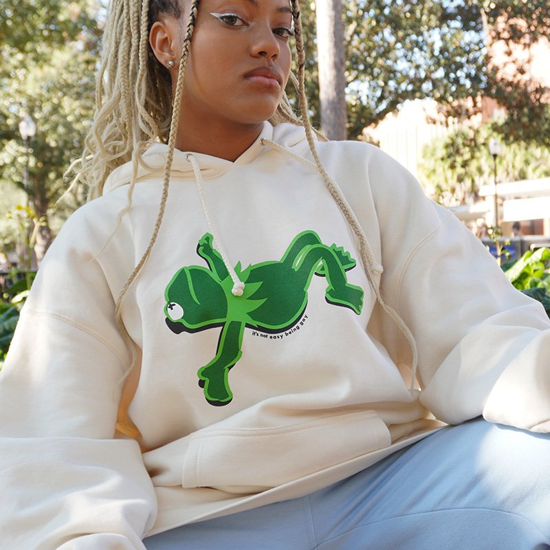 Girl Outside Wearing Kermit Frog Hoodie Off-White It's Not Easy Being Gay Subtle Gay Pride Queer Fashion LGBTQ Clothing Inclusive Apparel