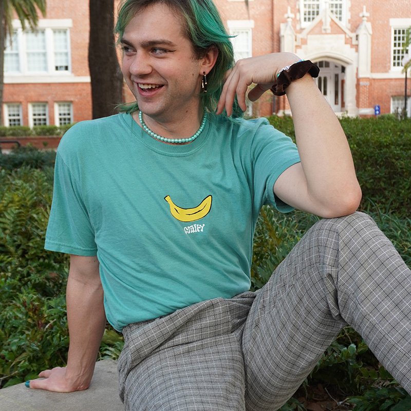 Banana Fruity Teal Shirt Outside Sit Blue Necklace Blue T-Shirt Subtle Gay Pride Queer Fashion LGBTQ Clothing Inclusive Apparel